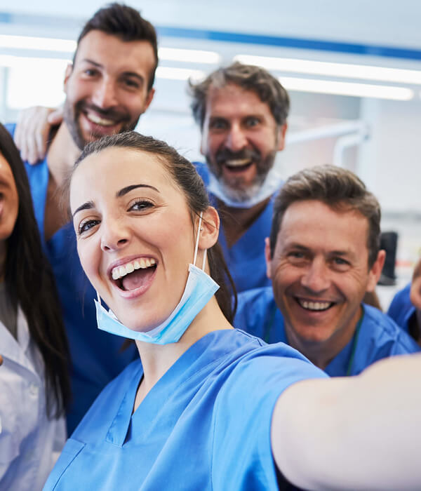 A team of healthcare professionals taking a selfie together