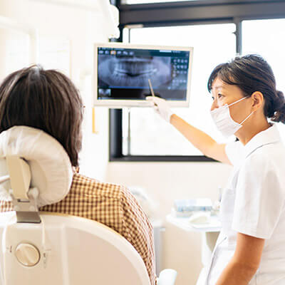 Dentist showing a teeth xray to a patient